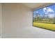 Screened patio overlooks grassy backyard and trees at 9433 Barnacle Ln, Parrish, FL 34219