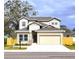 Two-story house with beige siding, gray roof, and a two-car garage at 3033 54Th N Ave, St Petersburg, FL 33714
