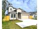Two-story house with beige siding, gray roof, and a fenced backyard at 3033 54Th N Ave, St Petersburg, FL 33714