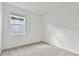 Simple bedroom with neutral wall and carpet, featuring a window with blinds at 9461 Shorebird Ct, Parrish, FL 34219