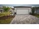 House exterior featuring a white garage and paver driveway at 9461 Shorebird Ct, Parrish, FL 34219