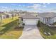 Single-story home with gray roof, white garage door, and landscaped yard at 9461 Shorebird Ct, Parrish, FL 34219