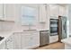 White kitchen cabinets, stainless steel appliances, and white quartz countertops at 9461 Shorebird Ct, Parrish, FL 34219
