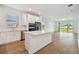 Modern kitchen with white cabinets, stainless steel appliances, and island at 9461 Shorebird Ct, Parrish, FL 34219