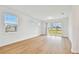 Living area with hardwood floors, multiple windows, and sliding glass doors at 9461 Shorebird Ct, Parrish, FL 34219