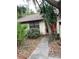 Ranch-style home with a red door and walkway at 2953 Yucca Ct, Palm Harbor, FL 34684