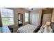 Well-lit bedroom with a full-size bed and a large mirror at 31422 Briars Ml, San Antonio, FL 33576