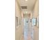 Light-filled hallway with tile floors and neutral walls at 31422 Briars Ml, San Antonio, FL 33576