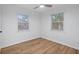 Cozy bedroom with light walls, ceiling fan, and wood-look flooring at 3170 6Th S Ave, St Petersburg, FL 33712