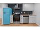 Modern kitchen with teal refrigerator and wood countertops at 3170 6Th S Ave, St Petersburg, FL 33712