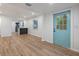 Light and bright living room with hardwood floors and blue door at 3170 6Th S Ave, St Petersburg, FL 33712