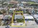 Aerial view showcasing property lines of single-story home with mature tropical landscaping and convenient location near local school at 422 86Th Ave, St Pete Beach, FL 33706