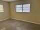 Cozy bedroom with neutral walls and carpet, brightened by natural light from two windows at 422 86Th Ave, St Pete Beach, FL 33706