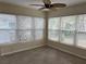 Relaxing sunroom features lots of windows with natural light and a ceiling fan at 422 86Th Ave, St Pete Beach, FL 33706