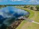 Community lakeside area features a dock. Enjoy outdoor relaxation at 13640 Eastfork Ln, Hudson, FL 34669