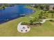 Community lakeside area features a fire pit and dock. Enjoy outdoor relaxation at 13640 Eastfork Ln, Hudson, FL 34669