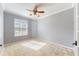 Bedroom with ceiling fan, neutral walls, and a window overlooking the outdoors at 16623 Ashton Green Dr, Lutz, FL 33558