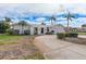 White single-story home with two-car garage and palm trees at 2000 Kansas Ne Ave, St Petersburg, FL 33703