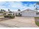 Front view of a two-car garage home with a neatly landscaped lawn at 2000 Kansas Ne Ave, St Petersburg, FL 33703