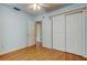 Light blue bedroom with wood floors and double door closet at 8495 109Th St, Seminole, FL 33772