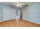 Bedroom with wood floors, ceiling fan and access to bathroom at 8495 109Th St, Seminole, FL 33772