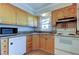 Galley kitchen with light wood cabinets and granite countertops at 8495 109Th St, Seminole, FL 33772