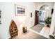 Inviting entryway with a red door, decorative shelving, and tiled floor at 905 Oxford Park Dr, Sun City Center, FL 33573