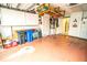 Garage with overhead storage and workshop area at 905 Oxford Park Dr, Sun City Center, FL 33573