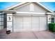 Garage with screen doors and landscaping at 905 Oxford Park Dr, Sun City Center, FL 33573