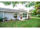 House exterior with screened porch and landscaping at 905 Oxford Park Dr # A, Sun City Center, FL 33573