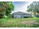 House exterior with landscaping and screened enclosure at 905 Oxford Park Dr, Sun City Center, FL 33573