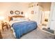 Bright main bedroom with king-size bed and ensuite bathroom at 905 Oxford Park Dr # A, Sun City Center, FL 33573