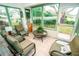 Relaxing sunroom with seating and access to the outdoors at 905 Oxford Park Dr, Sun City Center, FL 33573