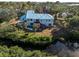 Aerial view showcasing home's rear, pool, and canal-side location at 1580 Mac Chesney Dr, Tarpon Springs, FL 34689