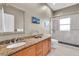 Bathroom boasts granite countertops, wood cabinets, and a walk-in shower at 1580 Mac Chesney Dr, Tarpon Springs, FL 34689