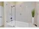 Bathroom with shower/tub combo, white tile, and a modern design at 1580 Mac Chesney Dr, Tarpon Springs, FL 34689