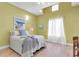 Cozy bedroom with a queen-size bed and light-colored walls at 1580 Mac Chesney Dr, Tarpon Springs, FL 34689