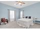 Light blue bedroom with queen-size bed, two nightstands and carpeting at 1580 Mac Chesney Dr, Tarpon Springs, FL 34689