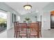 Bright dining room with wood table and access to deck at 1580 Mac Chesney Dr, Tarpon Springs, FL 34689