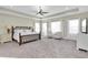 Spacious main bedroom with large bed, two armchairs, and plenty of natural light at 1580 Mac Chesney Dr, Tarpon Springs, FL 34689