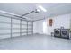 Spacious garage with epoxy flooring, washer, dryer, and utility sink, featuring an automatic garage door opener at 2909 W Fountain Blvd, Tampa, FL 33609