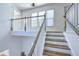 Bright staircase with wood treads, white risers and spindles, with lots of natural light from upper landing windows at 2909 W Fountain Blvd, Tampa, FL 33609