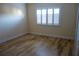 Bedroom with hardwood floors and white shuttered window providing natural light at 4108 Pinelake Ln # 102, Tampa, FL 33618