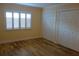 Bedroom with hardwood floors, white shuttered window, and double closets at 4108 Pinelake Ln # 102, Tampa, FL 33618