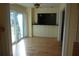 Living area with sliding glass door, hardwood floors and built in storage at 4108 Pinelake Ln # 102, Tampa, FL 33618