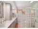 Bathroom featuring double sinks, a cabinet, a stand up shower, and unique lighting at 910 Oakwood Dr, Largo, FL 33770