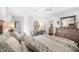 Well-decorated bedroom featuring a bed, dresser, vanity area, and view into the living room at 910 Oakwood Dr, Largo, FL 33770