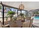 Bright dining room with a wooden table and chairs, along with an outdoor view of the pool area at 910 Oakwood Dr, Largo, FL 33770