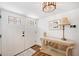 Bright entryway with white doors, console table, and decorative lamp at 910 Oakwood Dr, Largo, FL 33770