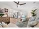 Cozy living room with neutral tones, comfortable seating, and stainless steel kitchen appliances in the background at 910 Oakwood Dr, Largo, FL 33770